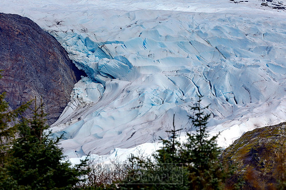 The darker bits in the ice are debis the glacier has carved on its way down